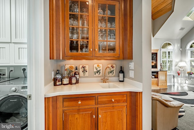 1217 Tullamore Cir, Chester Springs, PA 19425 - indoor wet bar featuring washer / clothes dryer and wood finished floors