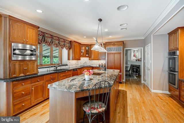 1217 Tullamore Cir, Chester Springs, PA 19425 - kitchen featuring built in appliances, brown cabinetry, backsplash, dark stone counters, and light wood-type flooring
