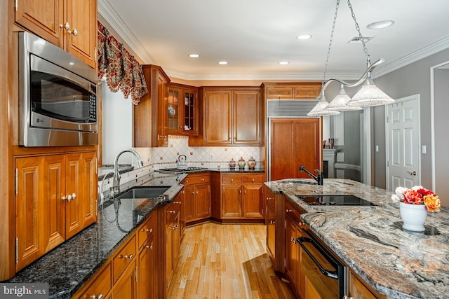 1217 Tullamore Cir, Chester Springs, PA 19425 - kitchen featuring built in appliances, a warming drawer, light wood-style flooring, brown cabinets, and crown molding