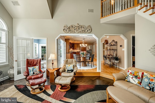 1217 Tullamore Cir, Chester Springs, PA 19425 - living area featuring a high ceiling, dark wood-style floors, a chandelier, and arched walkways