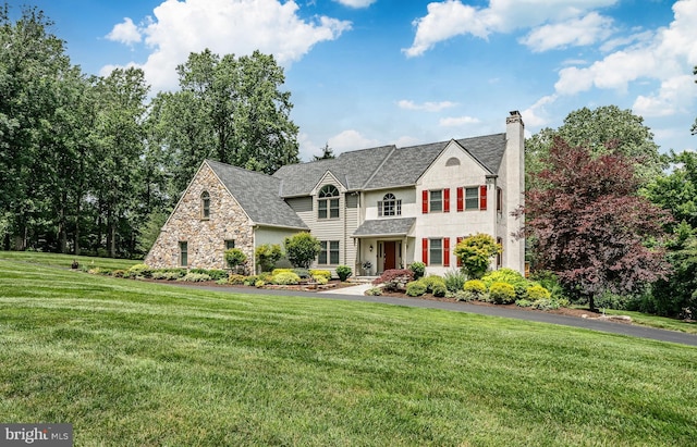 1217 Tullamore Cir, Chester Springs, PA 19425 - view of front of home featuring a chimney, a front yard, and stone siding