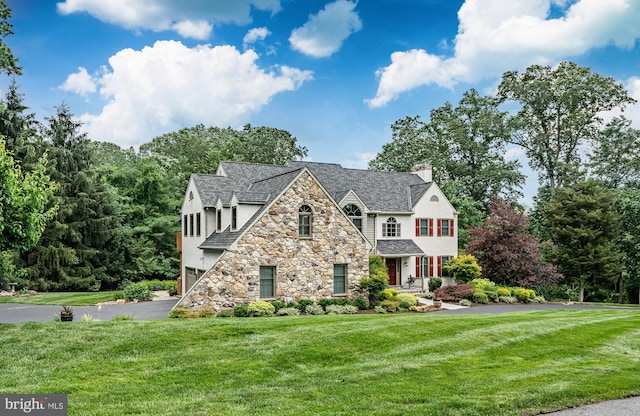 1217 Tullamore Cir, Chester Springs, PA 19425 - view of front of home featuring stone siding, stucco siding, a front lawn, and a chimney