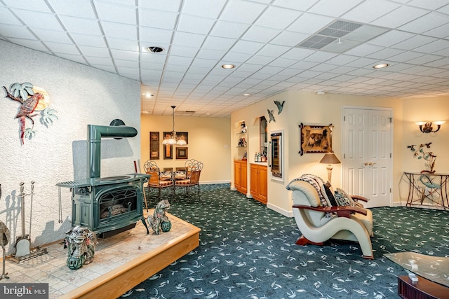 1217 Tullamore Cir, Chester Springs, PA 19425 - living room with dark colored carpet, a wood stove, and recessed lighting