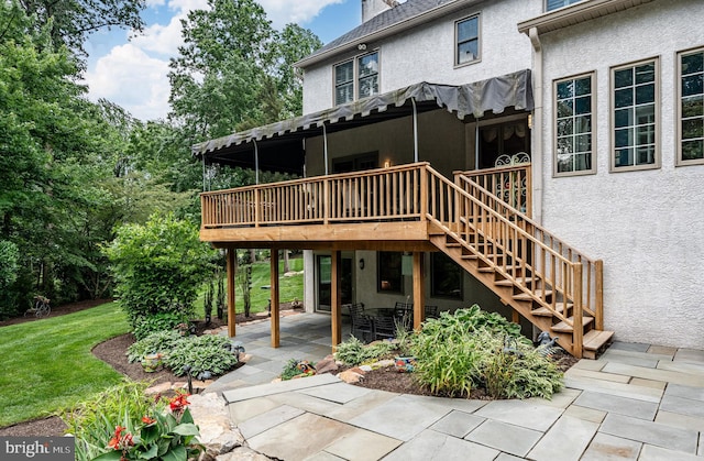 1217 Tullamore Cir, Chester Springs, PA 19425 - back of property featuring stucco siding, a deck, a lawn, a patio, and stairway
