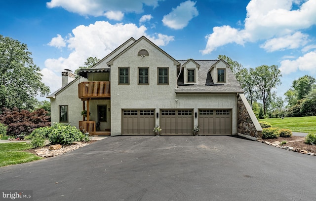 1217 Tullamore Cir, Chester Springs, PA 19425 - view of front of home featuring a balcony, an attached garage, stucco siding, and driveway