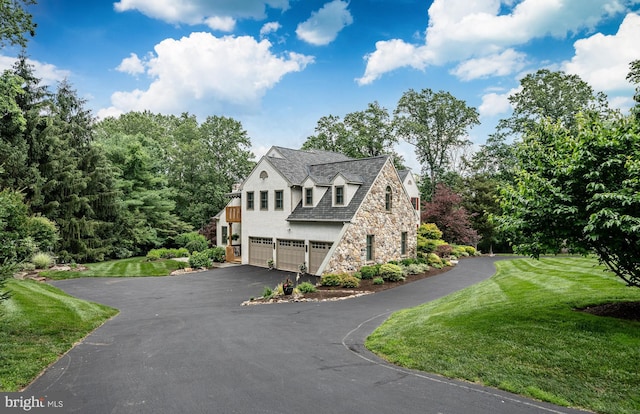 1217 Tullamore Cir, Chester Springs, PA 19425 - view of front of property with an attached garage, stone siding, driveway, and a front lawn