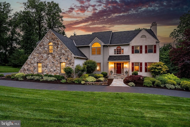 1217 Tullamore Cir, Chester Springs, PA 19425 - view of front of house featuring a lawn, a chimney, and stone siding