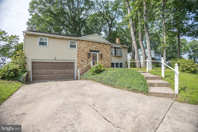 529 Appalachian Ave, Mechanicsburg, PA 17055 - raised ranch with an attached garage, a chimney, concrete driveway, brick siding, and a front lawn