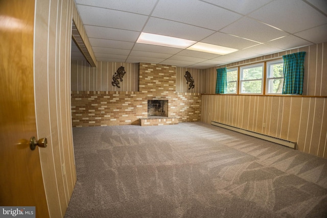 529 Appalachian Ave, Mechanicsburg, PA 17055 - basement with baseboard heating, a drop ceiling, carpet floors, a brick fireplace, and wood walls