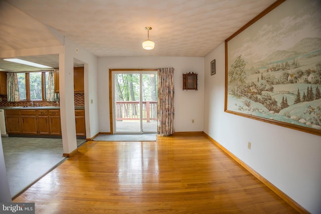 529 Appalachian Ave, Mechanicsburg, PA 17055 - unfurnished dining area featuring light wood-style flooring, baseboards, and a sink