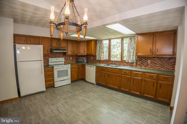 529 Appalachian Ave, Mechanicsburg, PA 17055 - kitchen featuring white appliances, under cabinet range hood, a sink, and brown cabinetry