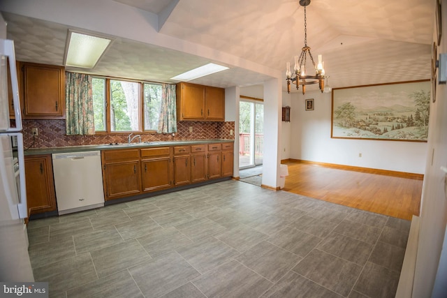 529 Appalachian Ave, Mechanicsburg, PA 17055 - kitchen featuring dishwasher, brown cabinetry, a chandelier, a sink, and decorative backsplash