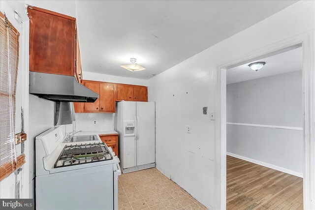 1240 Harding Dr, Havertown, PA 19083 - kitchen with white appliances, ventilation hood, light countertops, and brown cabinetry