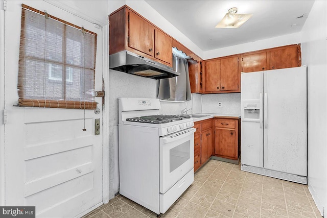 1240 Harding Dr, Havertown, PA 19083 - kitchen with white appliances, under cabinet range hood, brown cabinetry, and light countertops