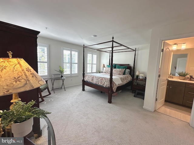 9402 James Macgowan Ln Unit 611, Owings Mills, MD 21117 - bedroom with light colored carpet, baseboards, and ensuite bathroom