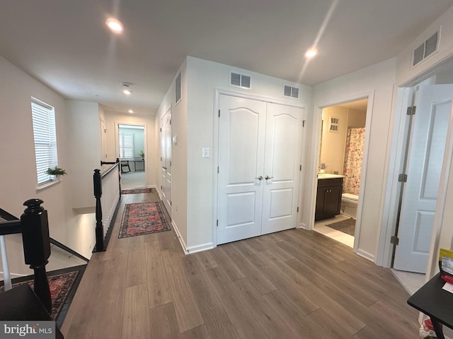 9402 James Macgowan Ln Unit 611, Owings Mills, MD 21117 - hall featuring an upstairs landing, wood finished floors, baseboards, and recessed lighting