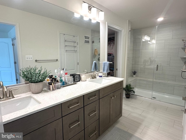 9402 James Macgowan Ln Unit 611, Owings Mills, MD 21117 - full bath featuring double vanity, a stall shower, a spacious closet, and tile patterned flooring