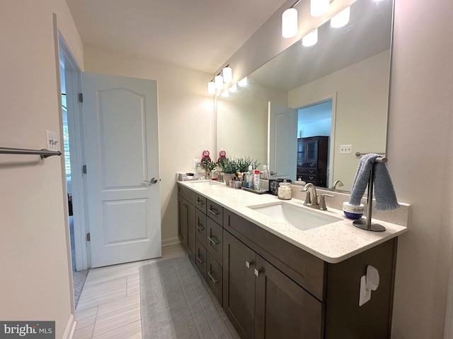 9402 James Macgowan Ln Unit 611, Owings Mills, MD 21117 - bathroom featuring double vanity and baseboards