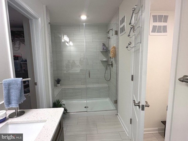 9402 James Macgowan Ln Unit 611, Owings Mills, MD 21117 - full bathroom with a shower stall, vanity, a spacious closet, and tile patterned floors
