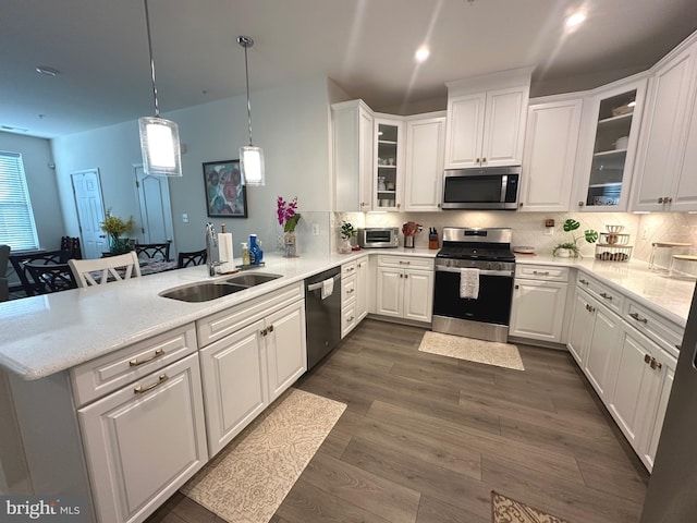 9402 James Macgowan Ln Unit 611, Owings Mills, MD 21117 - kitchen featuring stainless steel appliances, a peninsula, white cabinets, and a sink