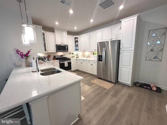 9402 James Macgowan Ln Unit 611, Owings Mills, MD 21117 - kitchen with appliances with stainless steel finishes, a sink, glass insert cabinets, light wood-style flooring, and white cabinets