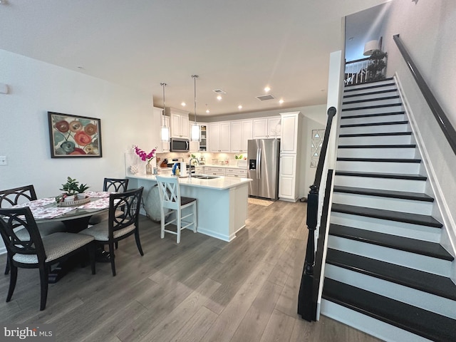 9402 James Macgowan Ln Unit 611, Owings Mills, MD 21117 - dining space with wood finished floors, stairs, and recessed lighting