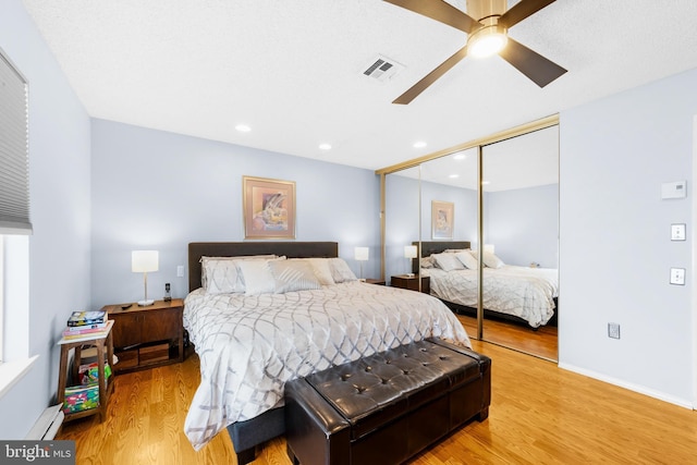 738 Prospect Rd, Monroe Township, NJ 08831 - bedroom with light wood finished floors, a closet, a baseboard heating unit, ceiling fan, and recessed lighting
