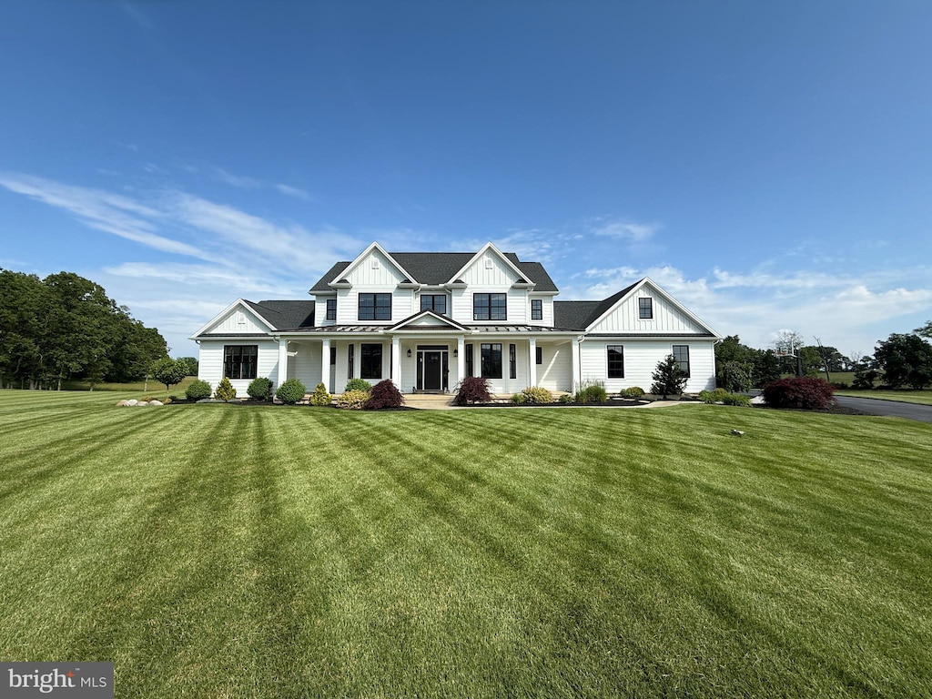 23 Blue Marlin Way, Mechanicsburg, PA 17050 - modern farmhouse style home with board and batten siding, a front yard, and a standing seam roof