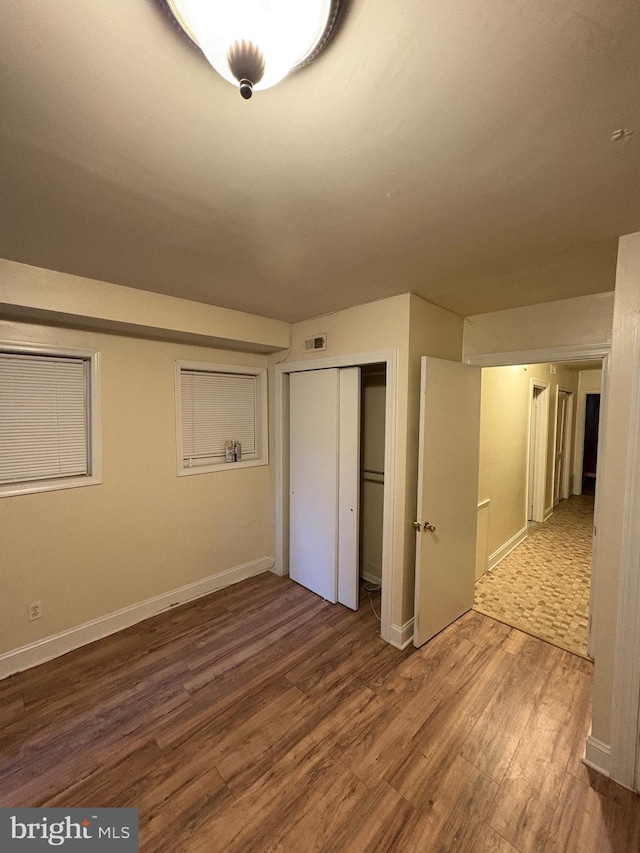 1313 Eutaw Pl, Baltimore, MD 21217 - unfurnished bedroom with wood finished floors and a closet