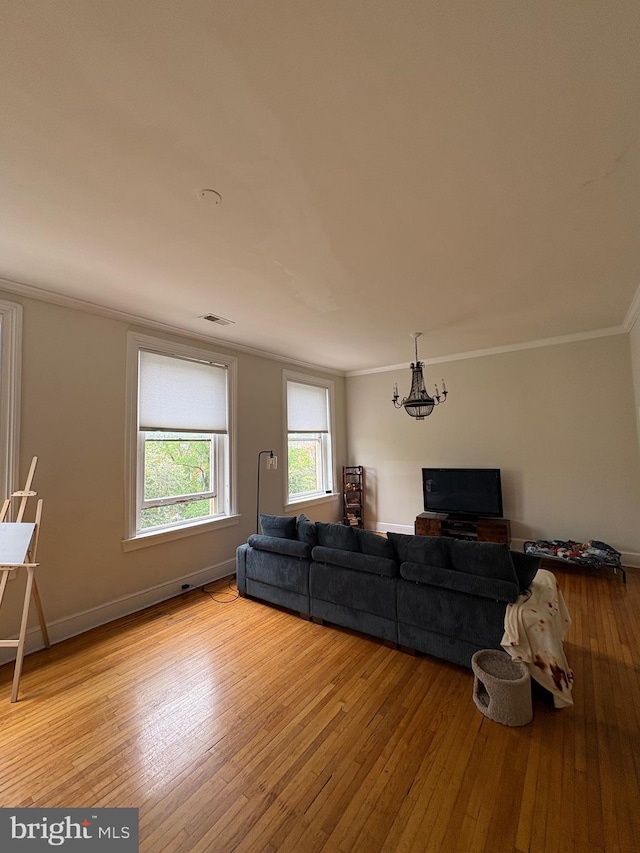 1313 Eutaw Pl, Baltimore, MD 21217 - living room with a chandelier, light wood-style flooring, and crown molding