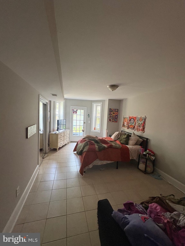 1313 Eutaw Pl, Baltimore, MD 21217 - bedroom with light tile patterned floors and access to exterior