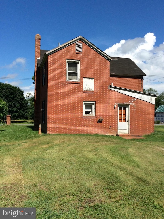 529 Oldtown Rd, Goldsboro, MD 21636 - rear view of property with brick siding, a chimney, and a lawn