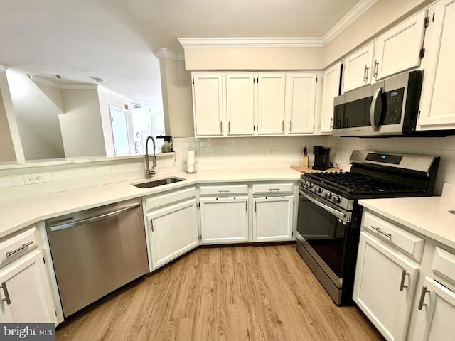 6820 Jade Ct, Capitol Heights, MD 20743 - kitchen with appliances with stainless steel finishes, ornamental molding, light wood-type flooring, tasteful backsplash, and light countertops
