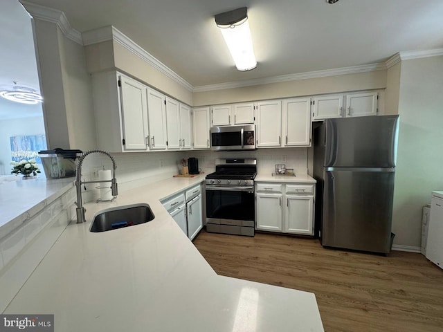 6820 Jade Ct, Capitol Heights, MD 20743 - kitchen with stainless steel appliances, decorative backsplash, dark wood finished floors, white cabinetry, and ornamental molding