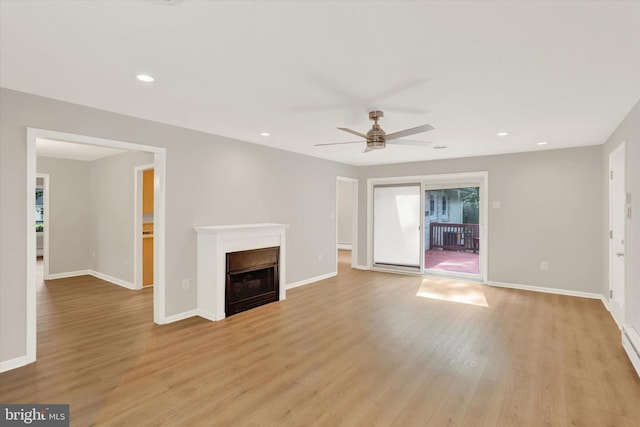 1216 Steamboat Rd, Shady Side, MD 20764 - unfurnished living room featuring light wood-type flooring, ceiling fan, a fireplace, and recessed lighting