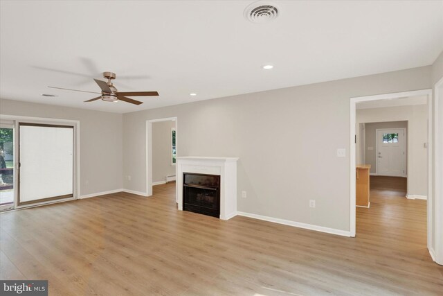1216 Steamboat Rd, Shady Side, MD 20764 - unfurnished living room with light wood finished floors, ceiling fan, a fireplace, and recessed lighting