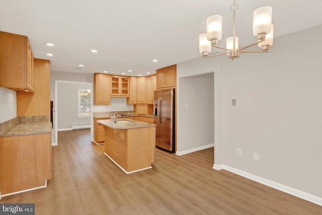 1216 Steamboat Rd, Shady Side, MD 20764 - kitchen featuring stainless steel fridge with ice dispenser, a baseboard heating unit, an island with sink, light wood-style flooring, and a chandelier