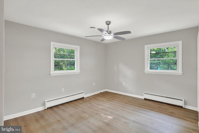 1216 Steamboat Rd, Shady Side, MD 20764 - unfurnished room featuring baseboard heating, plenty of natural light, and wood finished floors
