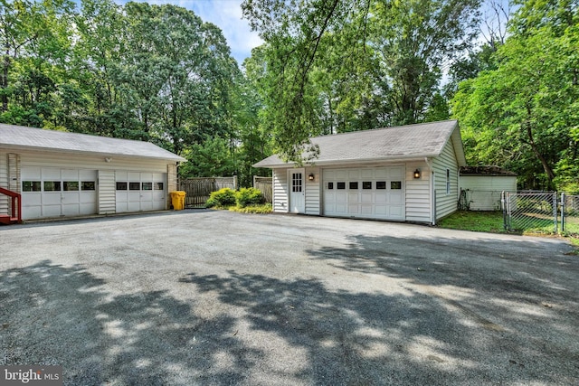 1216 Steamboat Rd, Shady Side, MD 20764 - view of side of property with an outdoor structure, a garage, and a gate
