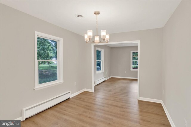 1216 Steamboat Rd, Shady Side, MD 20764 - empty room featuring a baseboard radiator, healthy amount of natural light, a chandelier, and a baseboard heating unit