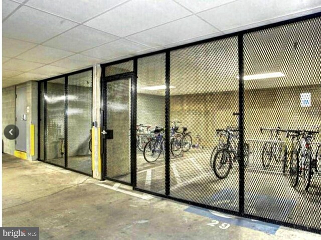 1451 Belmont St NW Unit 202, Washington, DC 20009 - wine area with unfinished concrete floors and a paneled ceiling