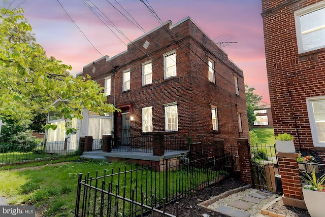 212 Division Ave NE, Washington, DC 20019 - view of side of property featuring a fenced front yard, brick siding, and a gate