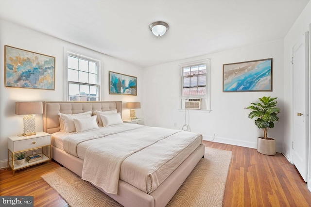 212 Division Ave NE, Washington, DC 20019 - bedroom featuring cooling unit, baseboards, and wood finished floors