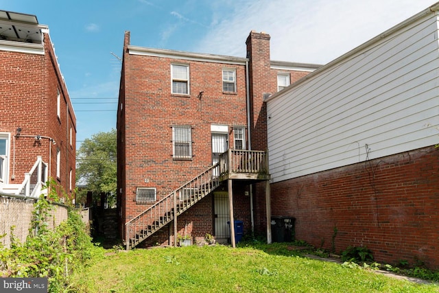 212 Division Ave NE, Washington, DC 20019 - rear view of property featuring stairs, brick siding, and a yard