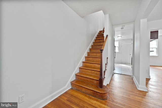 212 Division Ave NE, Washington, DC 20019 - stairs featuring baseboards, wood finished floors, and healthy amount of natural light