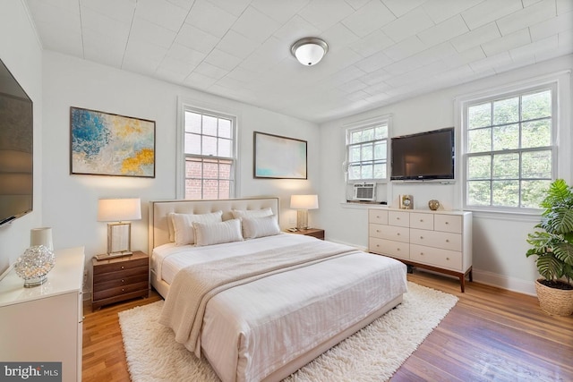 212 Division Ave NE, Washington, DC 20019 - bedroom featuring light wood-type flooring, baseboards, and cooling unit