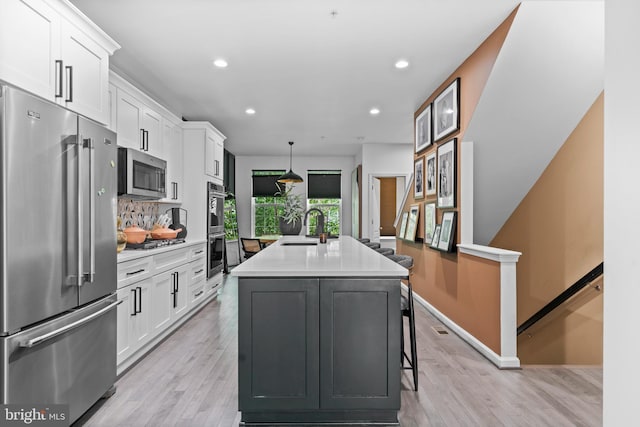 1611 Fernwood Dr, Upper Marlboro, MD 20774 - kitchen with appliances with stainless steel finishes, white cabinets, a kitchen island with sink, a sink, and recessed lighting