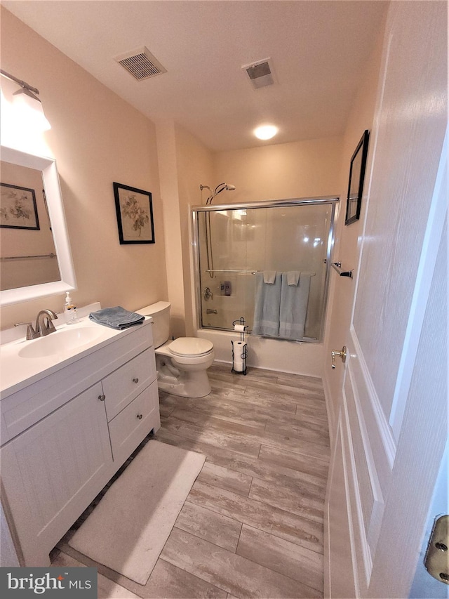 63 Briarwood Dr, Little Egg Harbor Twp, NJ 08087 - full bathroom featuring bath / shower combo with glass door, toilet, vanity, and wood finished floors