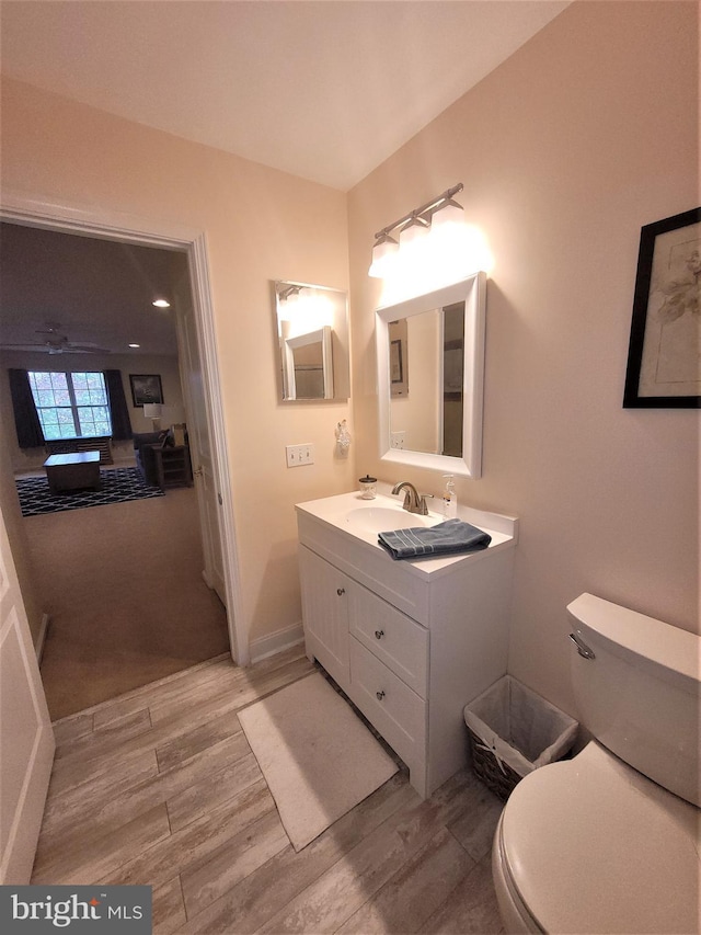 63 Briarwood Dr, Little Egg Harbor Twp, NJ 08087 - bathroom with wood finished floors, vanity, toilet, and baseboards