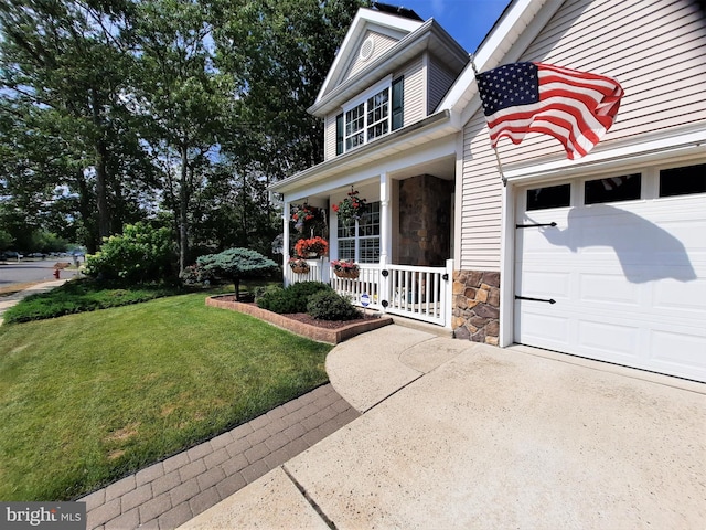 63 Briarwood Dr, Little Egg Harbor Twp, NJ 08087 - view of front of property with covered porch, stone siding, concrete driveway, a front lawn, and a garage